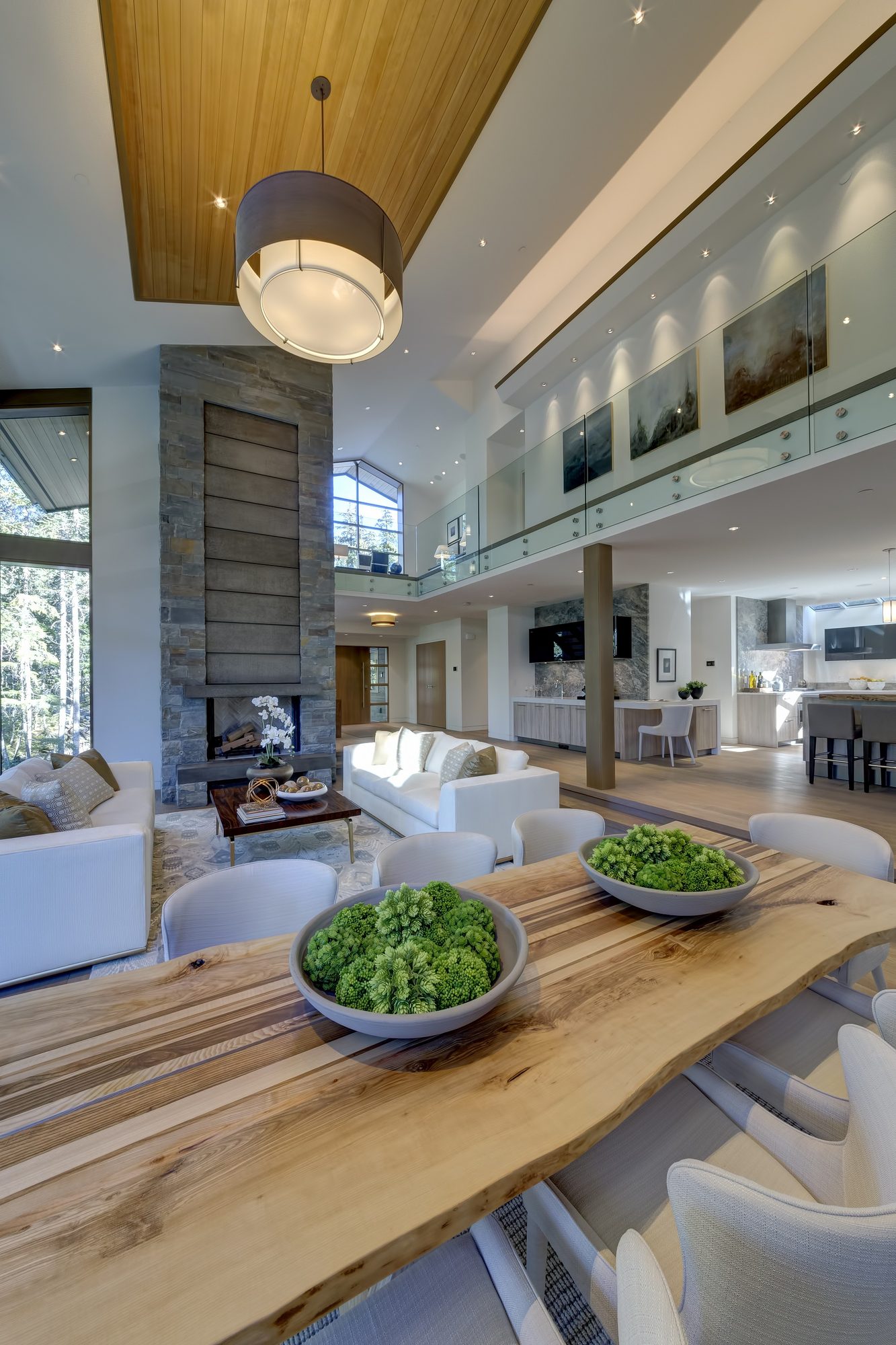 Interior of a Burj built home on Ancient Cedars Lane, Whistler, with a timber ceiling and a long dining table