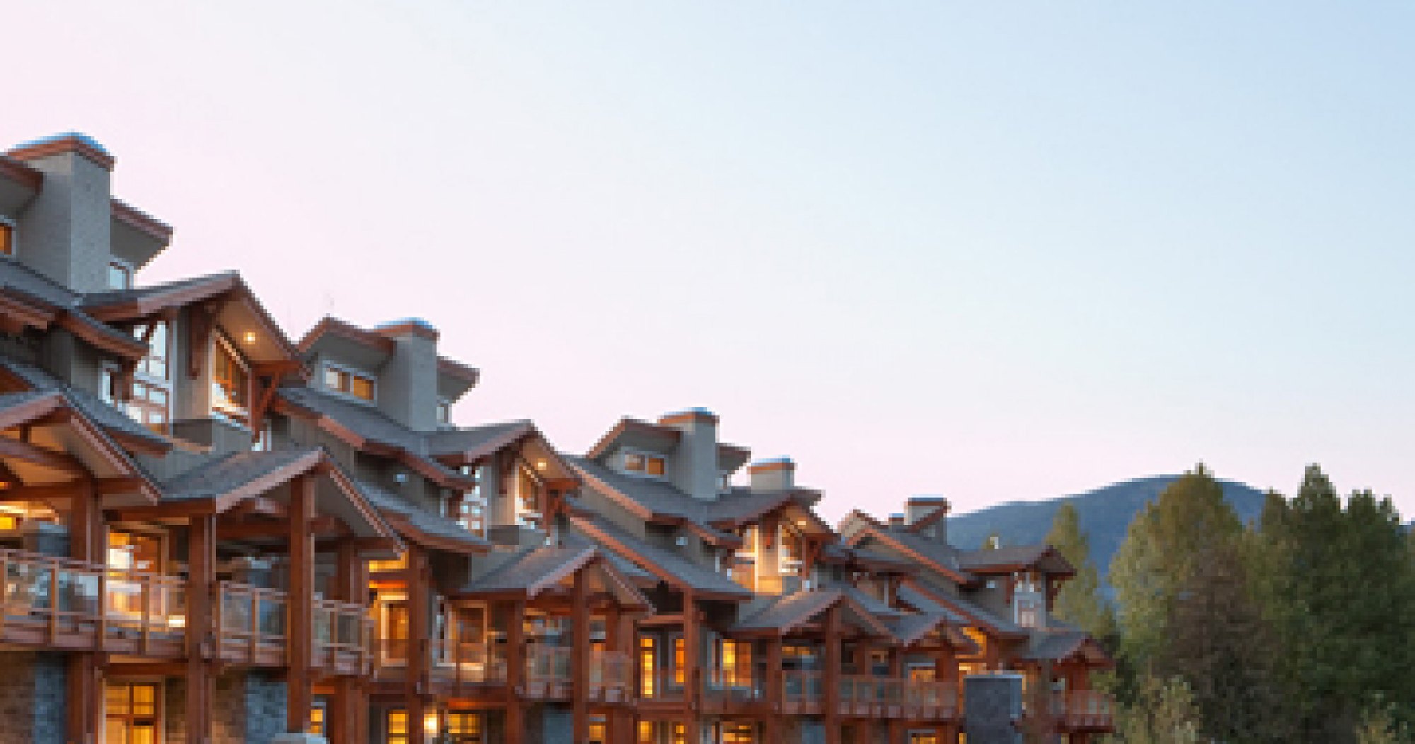 Fitzsimmons Walk in Whistler, creek side elevation in timber and shingle at dusk, built by Burj Enterprises