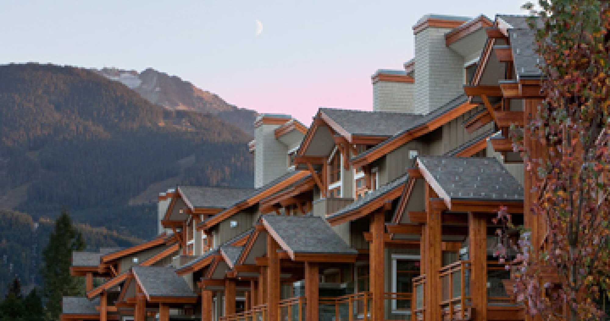 Timber and shingle elevations with layered rooflines and deep soffits at Fitzsimmons Walk in Whistler, building envelope work by Burj Enterprises
