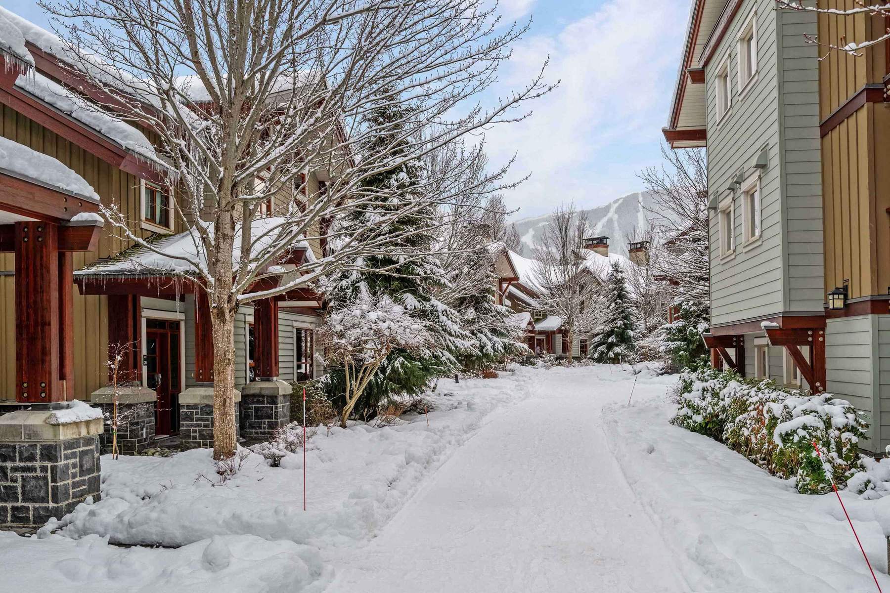 Snow covered walkway between the Fitzsimmons Walk buildings in Whistler, maintained by Burj Enterprises