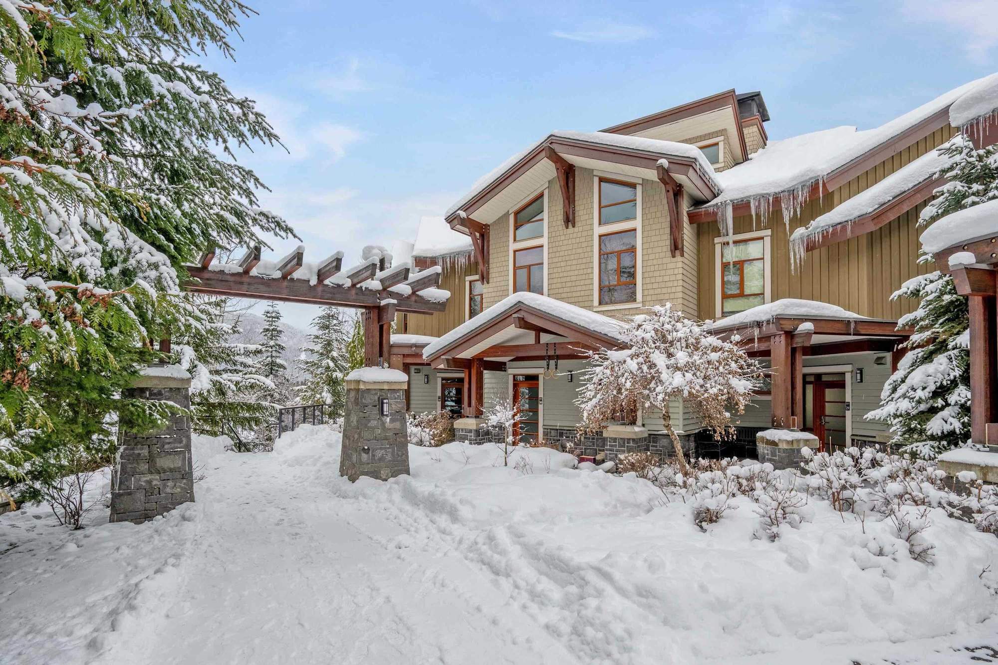 Fitzsimmons Walk in Whistler, siding and gables carrying deep winter snow, built by Burj Enterprises