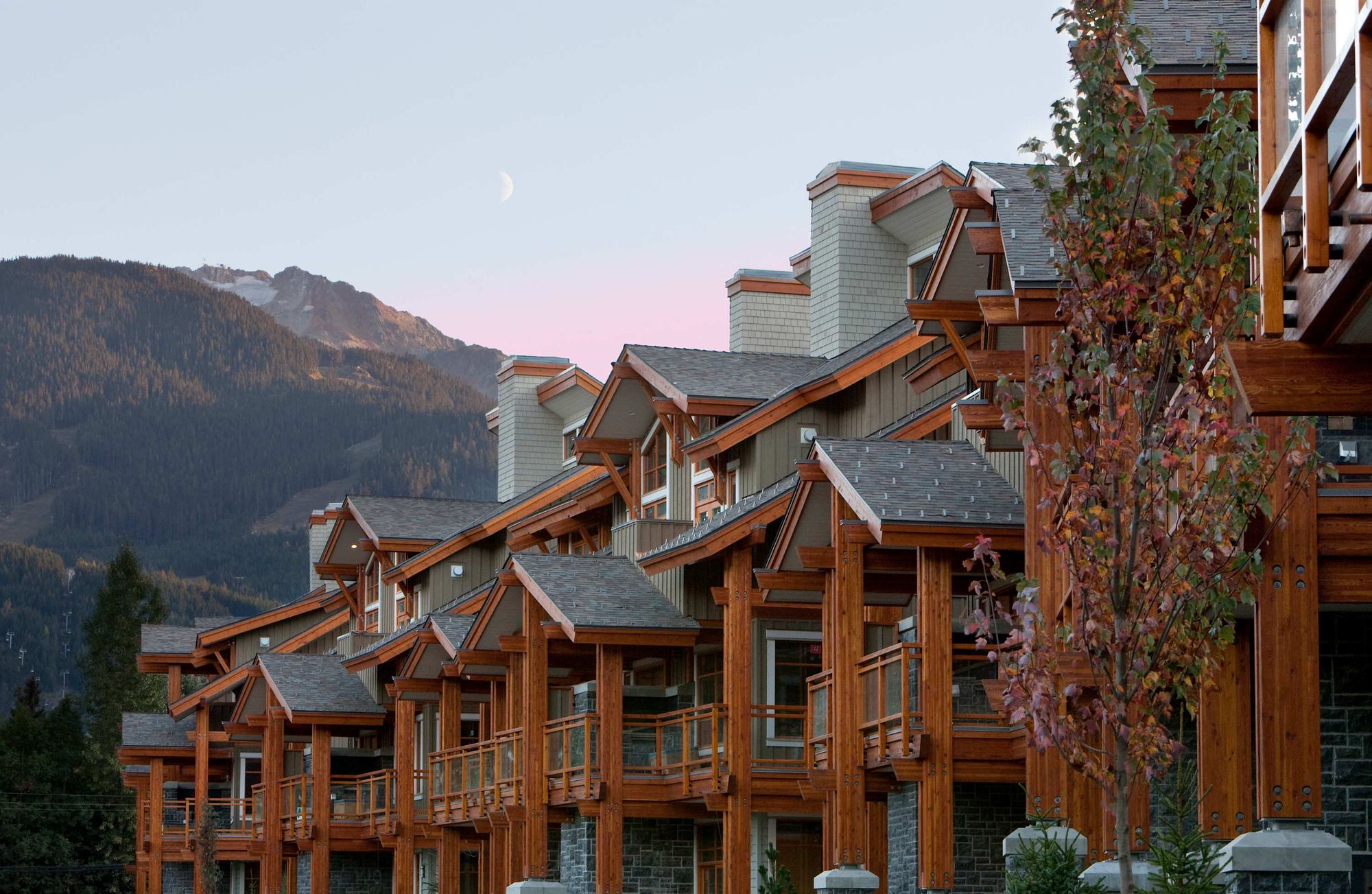 Fitzsimmons Walk in Whistler, townhome elevations and decks at dusk, built by Burj Enterprises