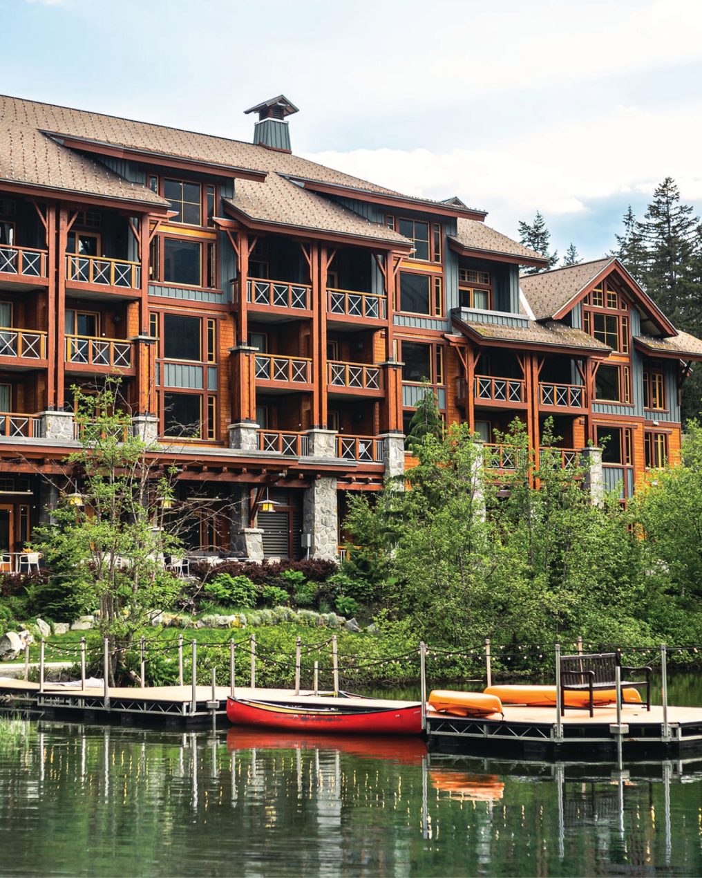 Nita Lake Lodge in Whistler, exterior lakefront elevation in timber, stone and shingle with balconies above the dock, built by Burj Enterprises