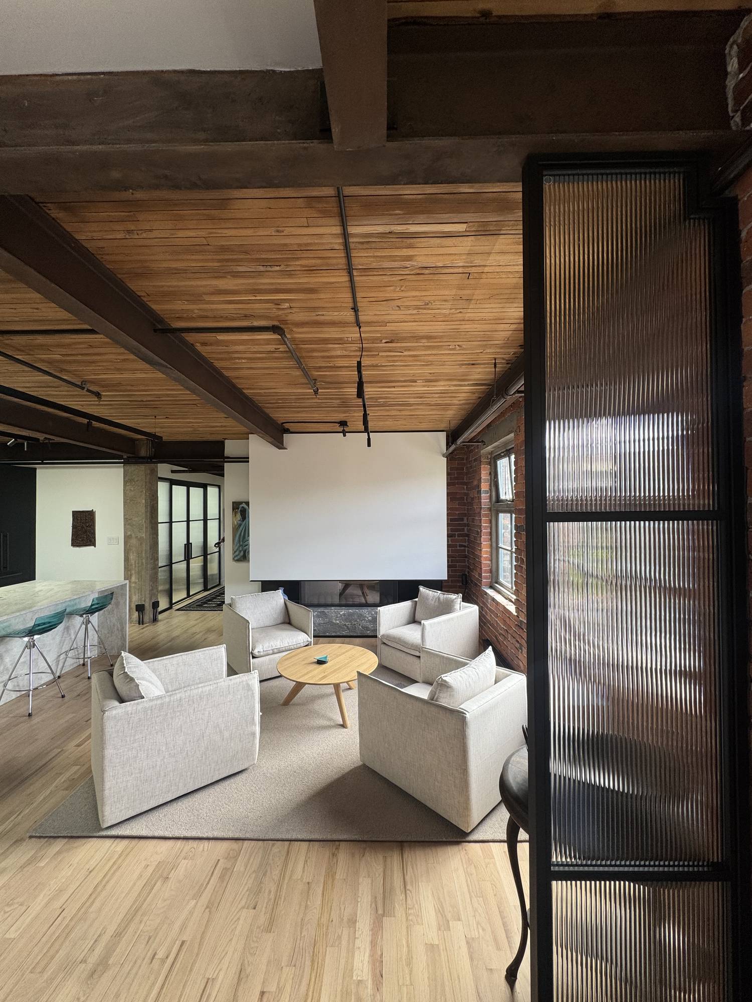 Powell, living area under a cedar plank ceiling carried on exposed timber beams, built by Burj Enterprises