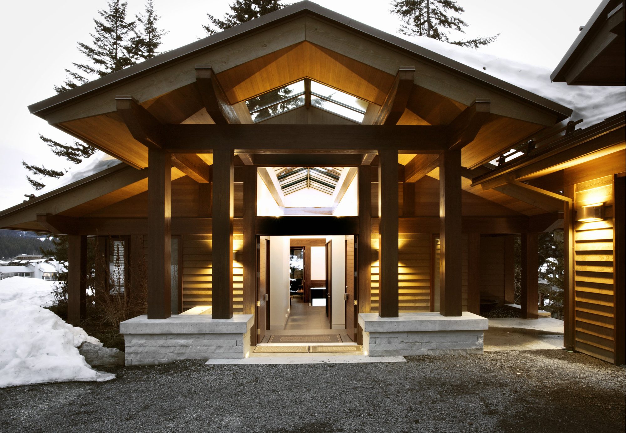 Timber and glass entry with a deep sheltering overhang at St. Antons in Whistler, built by Burj Enterprises