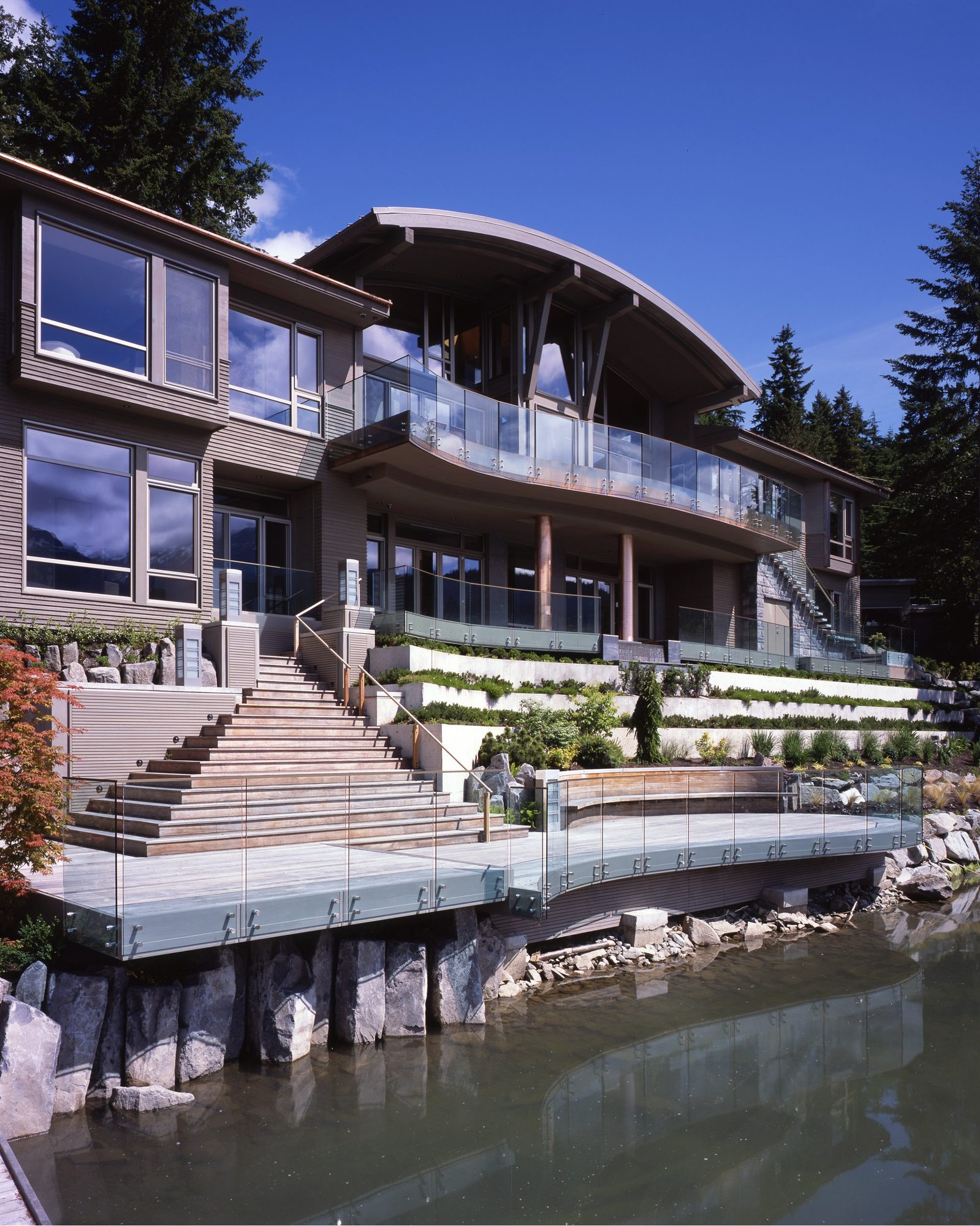 Lakefront elevation at Trudy's Landing in Whistler, timber and stone, built by Burj Enterprises